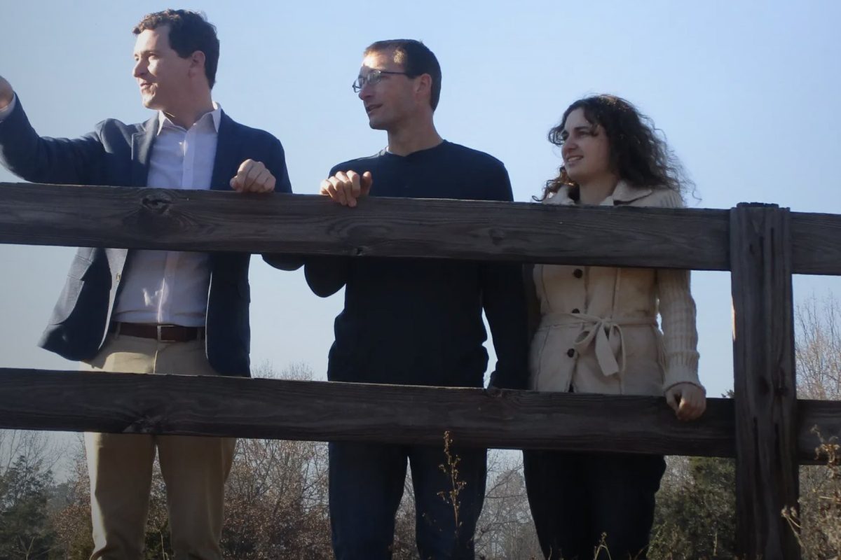 Damian Hall on the fence line with the House Hunters couple, from the HGTV episode